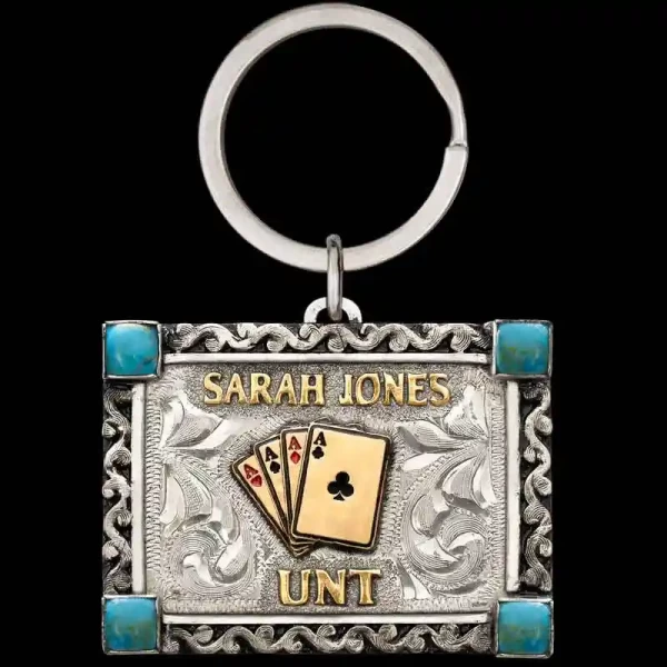 "Our High Noon Custom Keychain is crafted on a hand-engraved German Silver base, featuring Western-inspired scrollwork around the edges, stones in each corner, and Jeweler's Bronze lettering. Designed to be customizable, you can add your own letterin